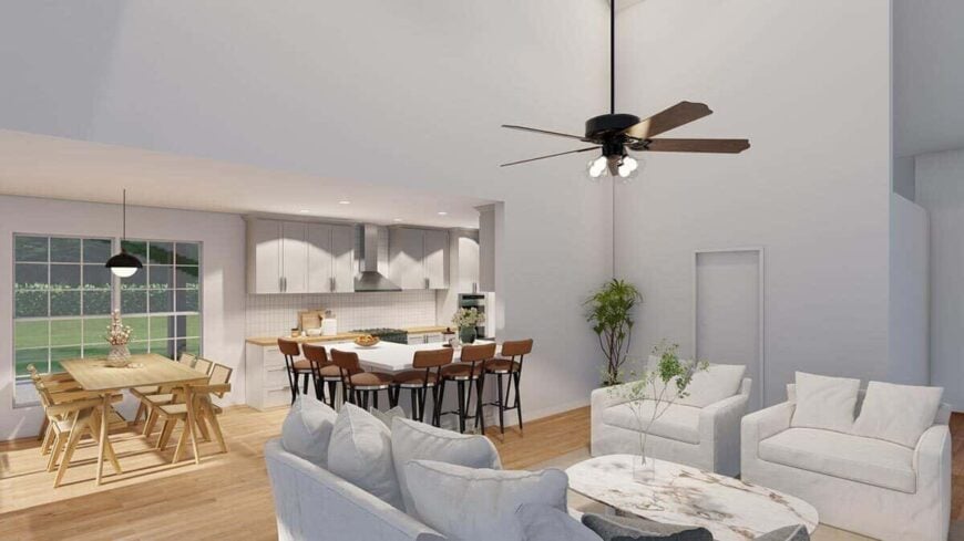 An open layout view of the kitchen, dining area, and two-story great room.