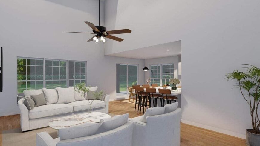 A traditional ceiling fan with lamps illuminates the great room.