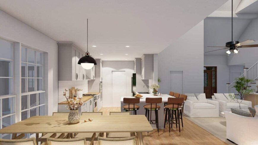 The kitchen features white cabinets and a peninsula paired with round bar stools.