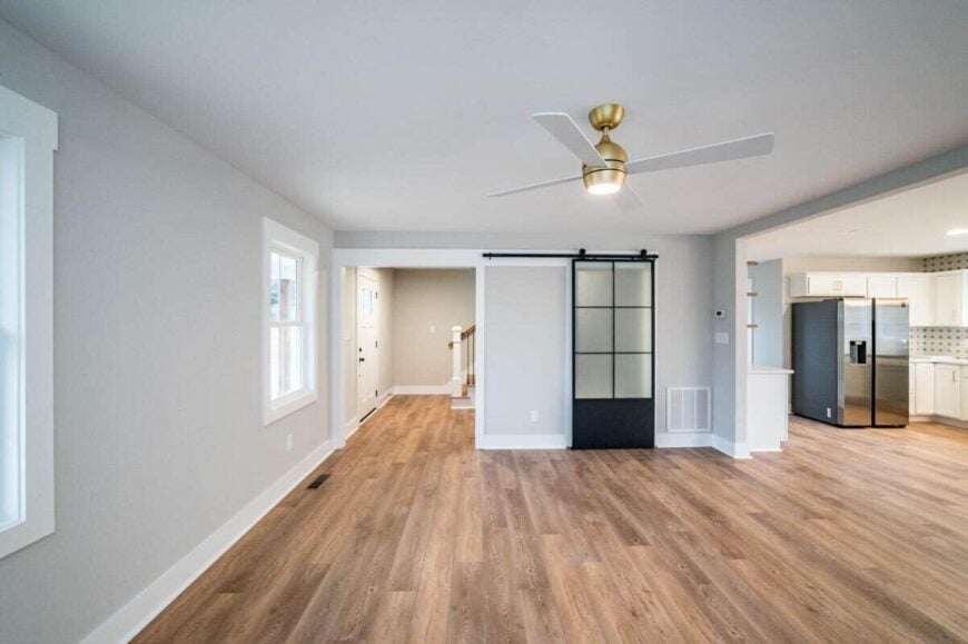 Living room with a modern ceiling fan mounted on the regular white ceiling.