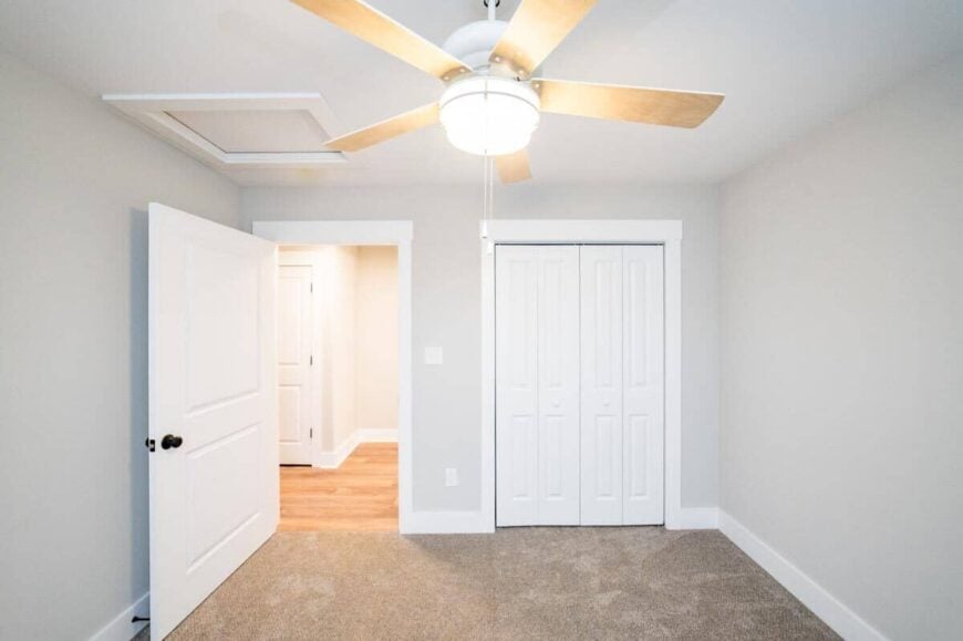 This bedroom mimics the walls and flooring of the second bedroom.