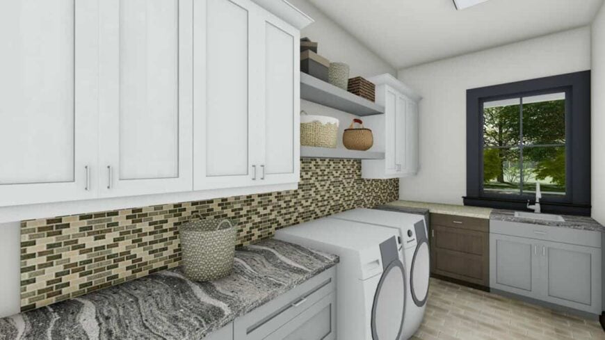 The laundry room is equipped with granite countertops, a front-load washer and dryer, a utility sink, and plenty of storage.