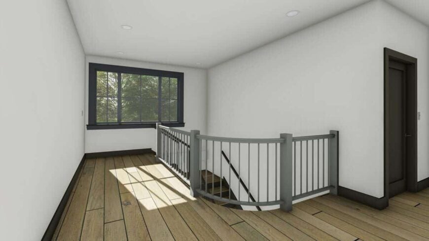Second-level balcony with a curved railing and a large window that brings natural light in.