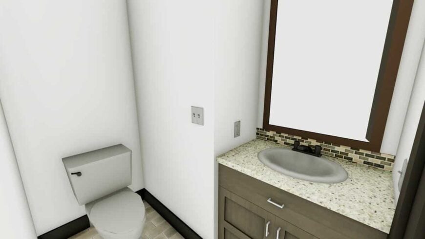 Powder room with a toilet and a sink vanity paired with a wooden framed mirror.