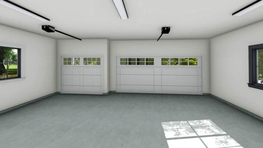 A spacious garage with concrete flooring and fits three vehicles comfortably.