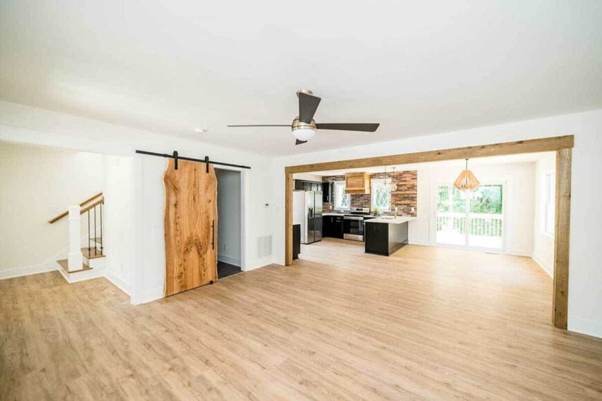 Rustic beams serve as a divider between the living room and the eat-in kitchen.