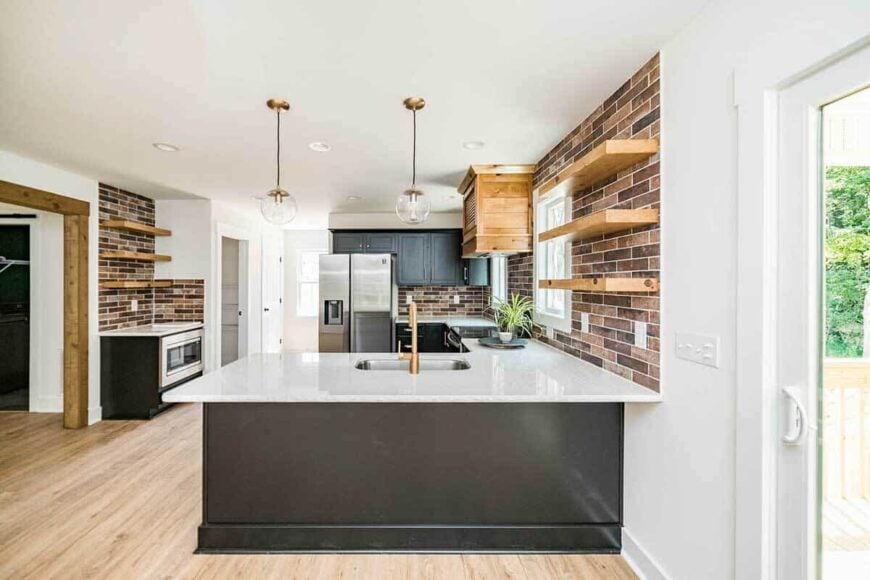 The kitchen includes a peninsula bar fitted with a sink.