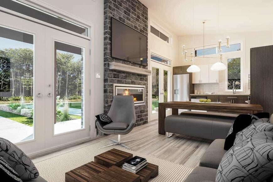 Two sets of french doors lead into the open living space warmed by a stone fireplace.