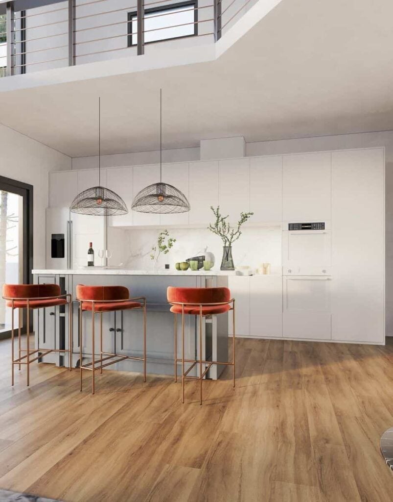 Kitchen with pristine white cabinets, white appliances, and a breakfast bar topped with oversized dome pendants.