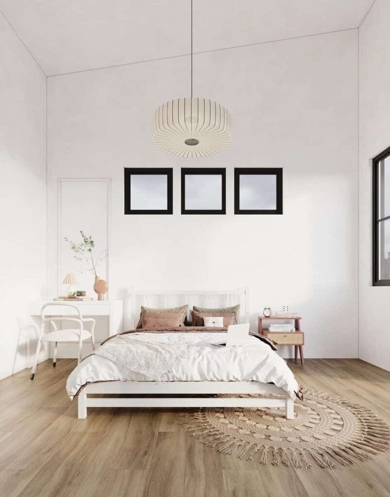 Primary bedroom with a cozy wooden bed flanked by a nightstand and a white desk.