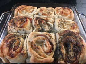 Baked Ham and Cheese Rolls on a pan.