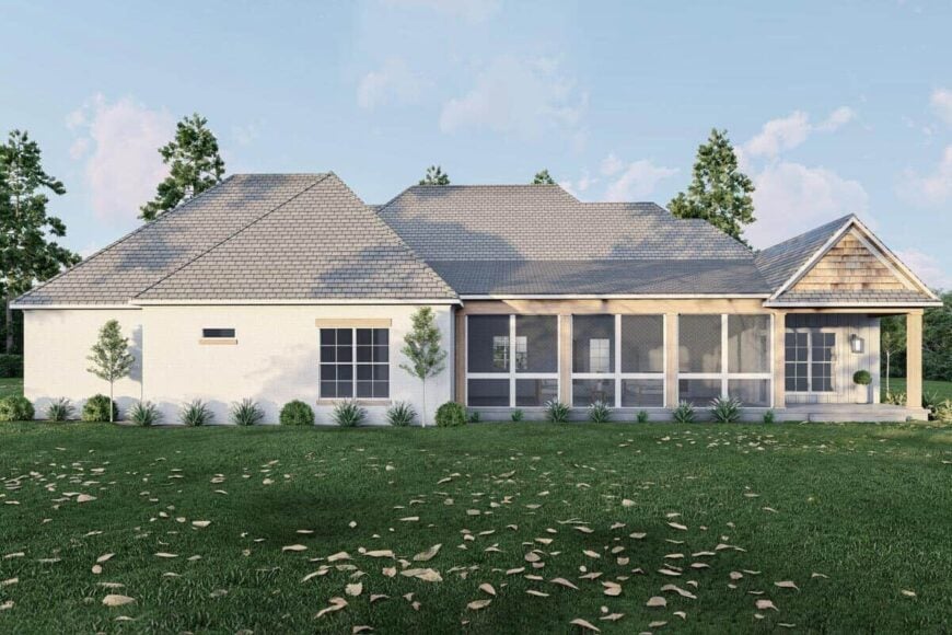 View of the house from the backyard showcasing its hipped and gable rooflines, wood accents, and partially screened porch.