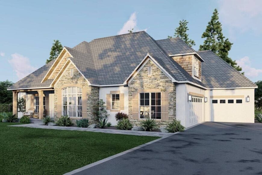 An asphalt driveway leads to the multiple garages.