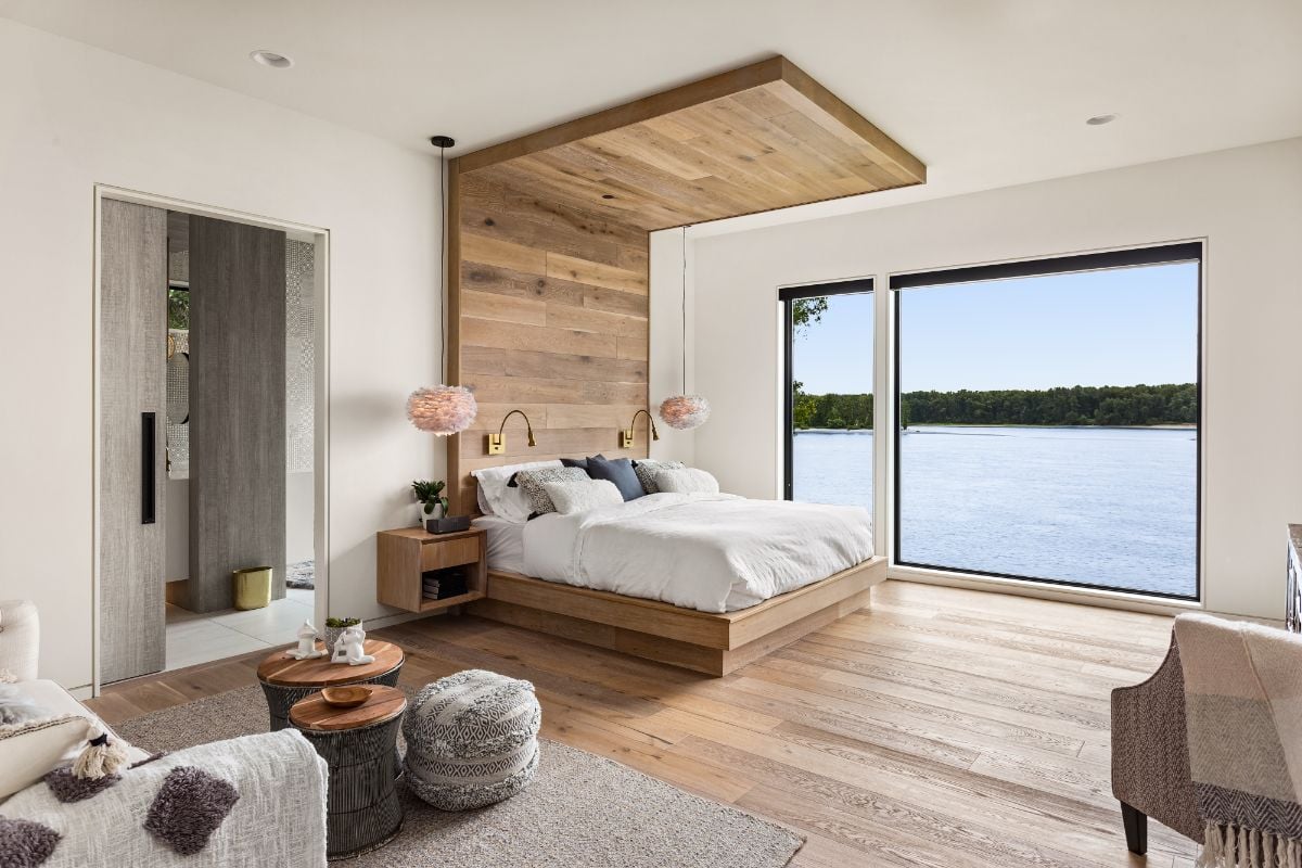 A large room with rustic wooden headboard.
