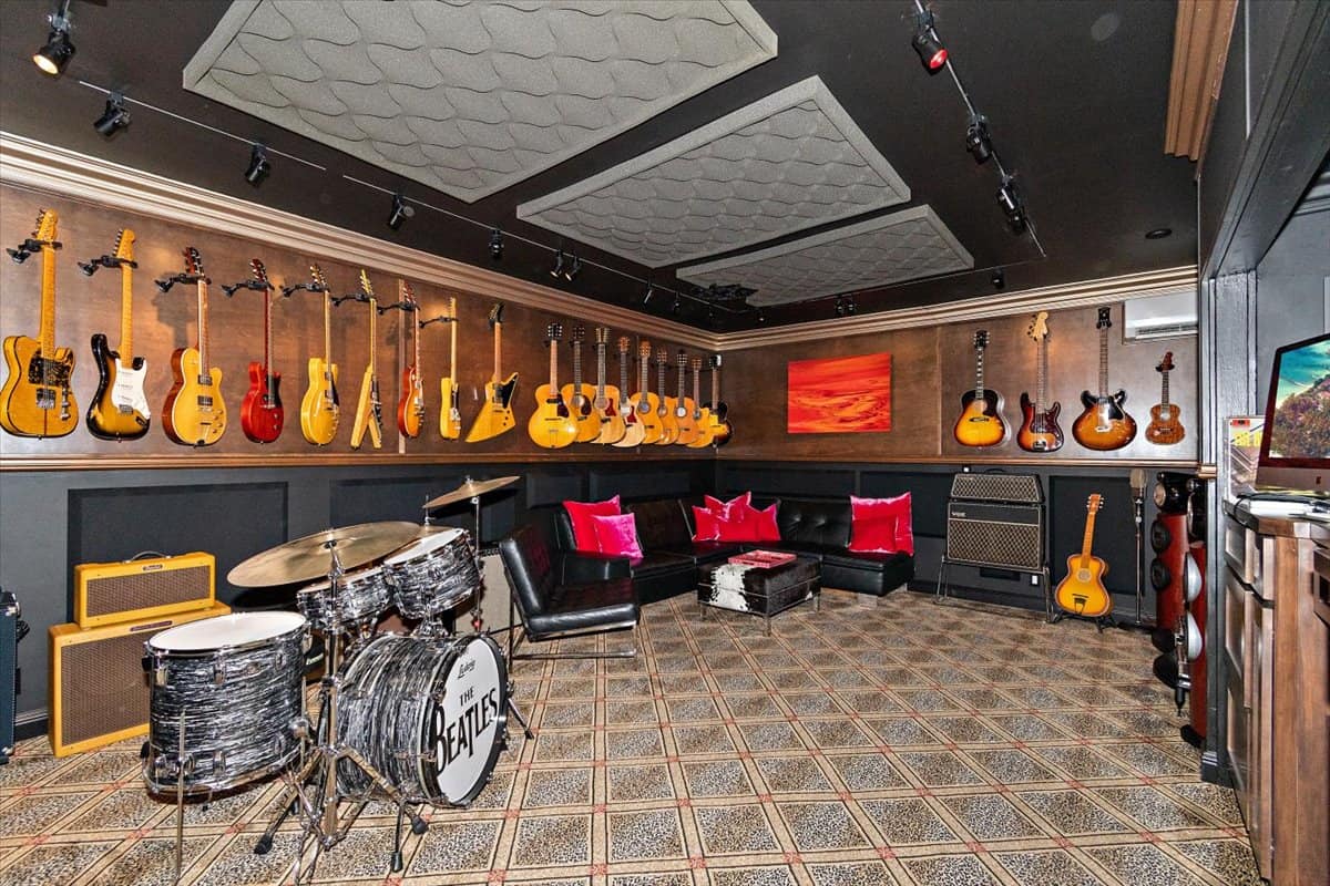 The music room has tons of classic guitars and a Beatles drum set. Image courtesy of Toptenrealestatedeals.com.