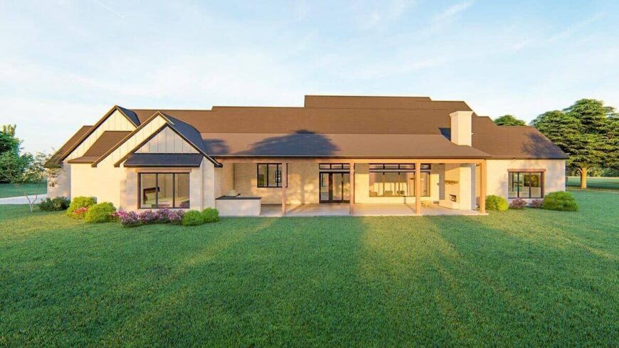 Rear rendering with an expansive porch equipped with a summer kitchen and an outdoor fireplace.
