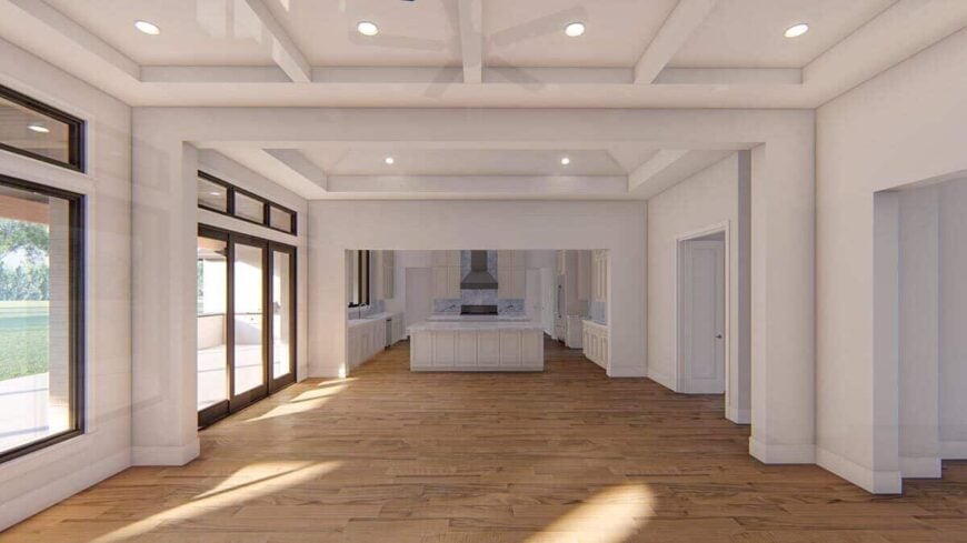 An open layout view of the living room, dining area, and kitchen separated by large open doorways.