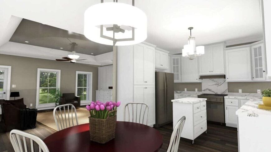 The eat-in kitchen is equipped with a round dining set, white cabinetry, slate appliances, and a center island.