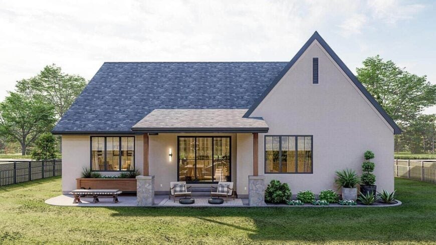 Rear rendering with an open patio and a covered porch supported by stone-based columns.