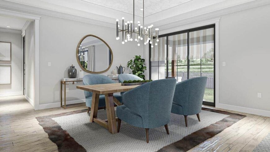 The formal dining room has a contemporary dining set and a large trio of windows overlooking the front yard.