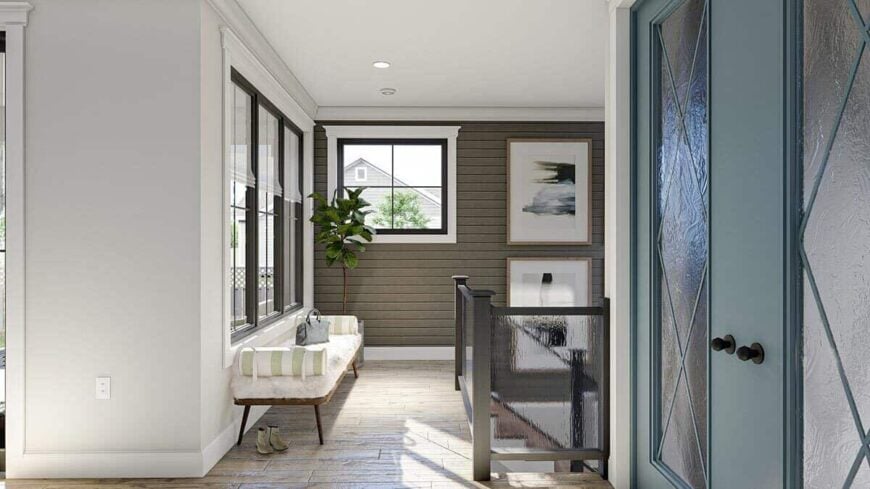 A furry bench with striped bolsters sits in the entry.