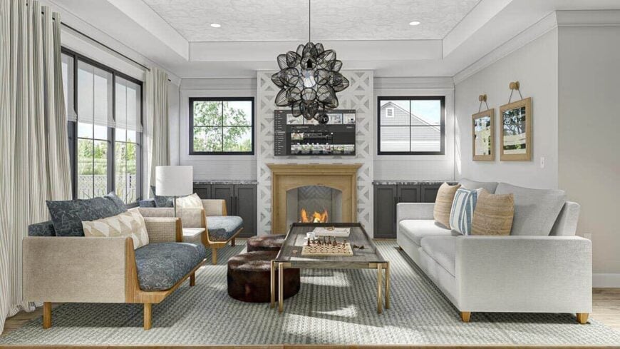 Living room with a tray ceiling and a cozy fireplace flanked by base cabinets and picture windows.