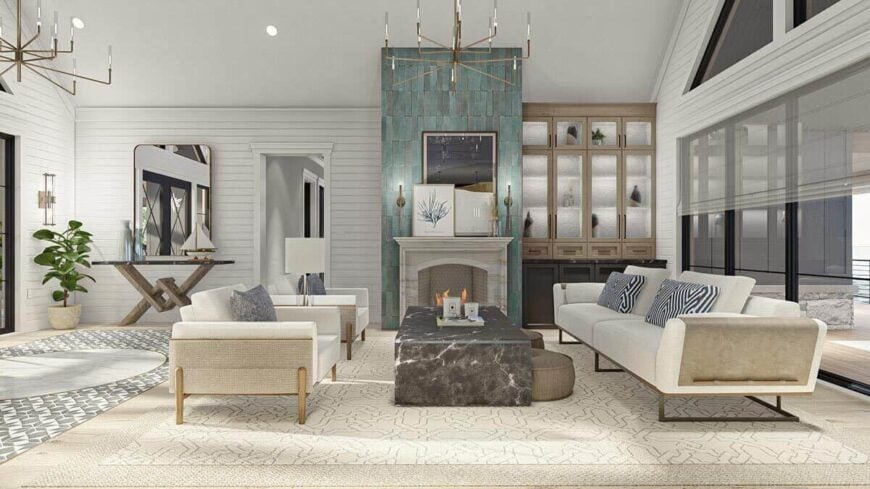 The foyer opens to the living room equipped with a fireplace and modern furnishings.