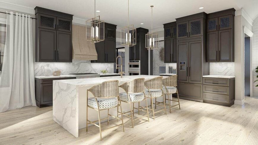 The kitchen has contrasting cabinetry, marble countertops, and a waterfall island lined with wicker bar stools.