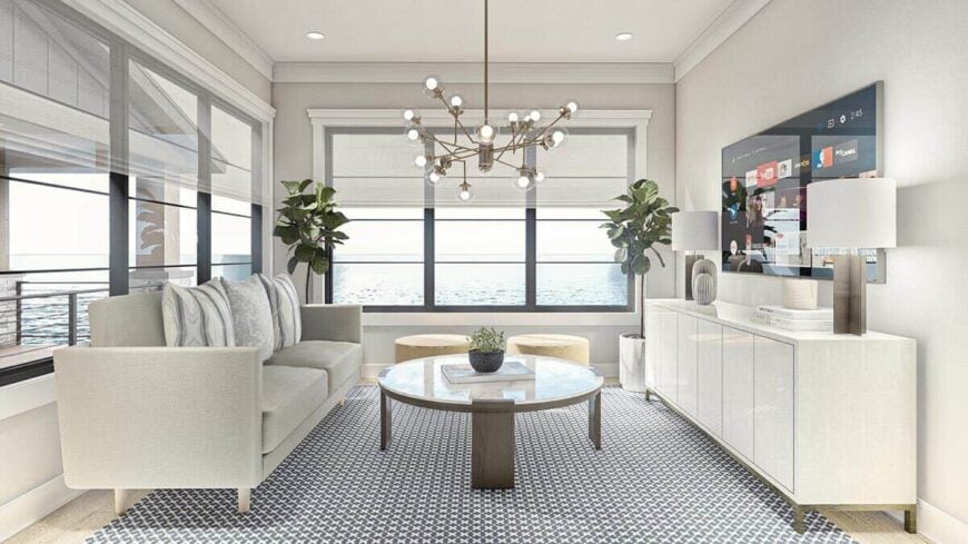 The family room has also stunning lake views and a TV mounted above the light wood console table.