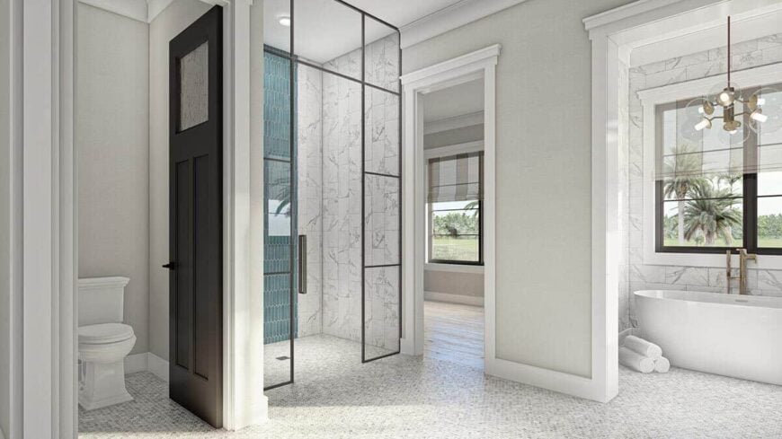 The primary bathroom includes a toilet room and a walk-in shower enclosed in framed glass panels.