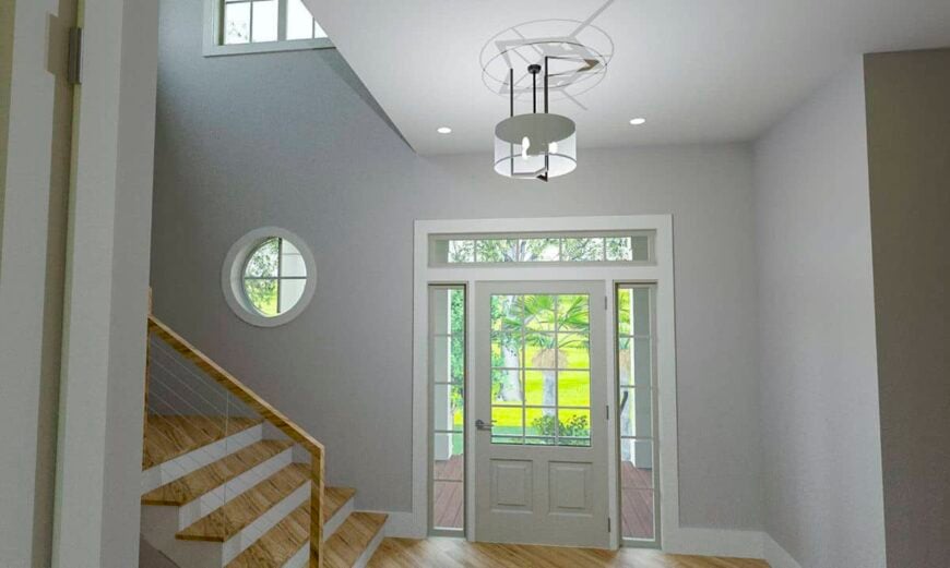 Foyer with a glazed entry door, a wooden staircase, and a drum chandelier.