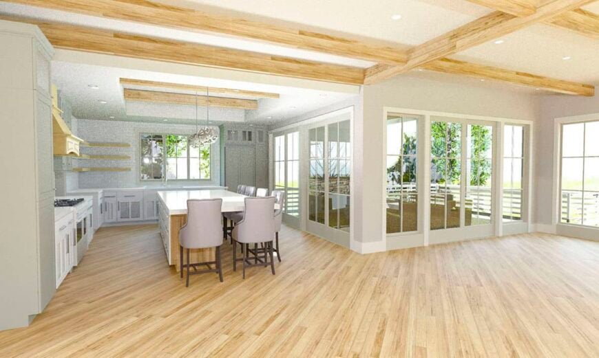 An open layout view of the living room, dining area, and kitchen with hardwood flooring.