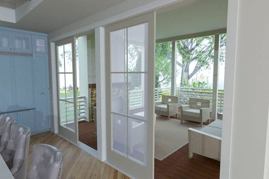 Sliding glass doors extend the kitchen onto a covered porch warmed by a stone fireplace.