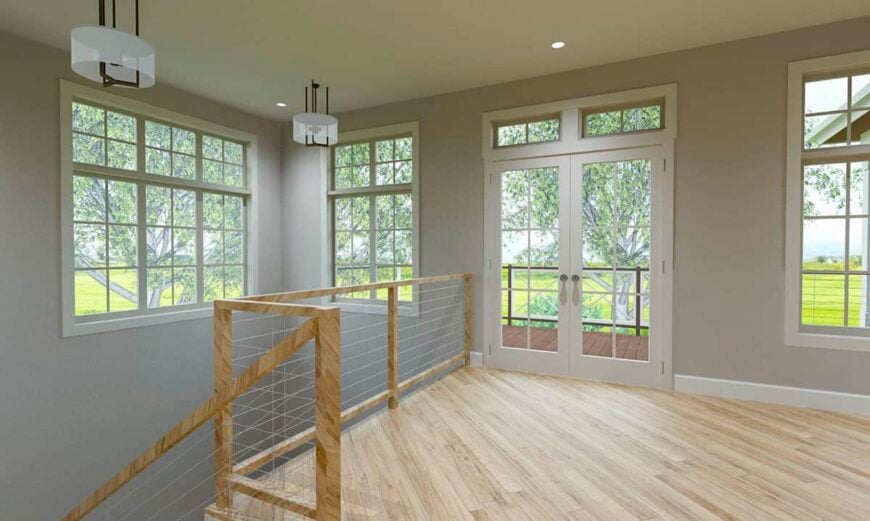 The kitchen has clerestory windows, a hardwood floor, and a french door that opens onto a deck.
