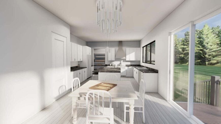 The kitchen has white cabinetry, marble countertops, a breakfast island, and an adjoining dining space that extends onto the rear deck.