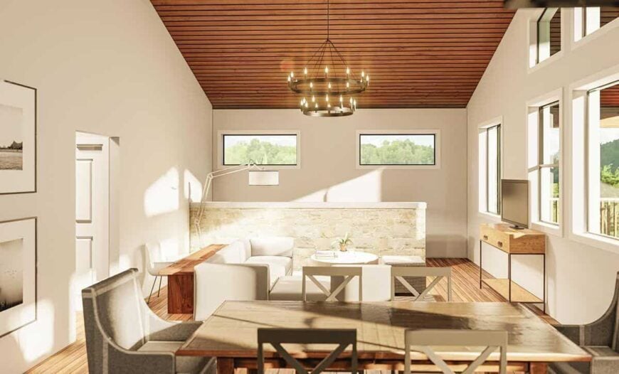The combined living and dining areas have modern furnishings, a two-tier round chandelier, and a TV that sits on a console table.