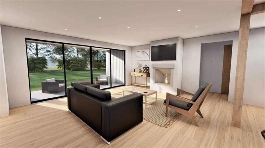 The great room has a fireplace, a TV, and large sliding glass doors that open onto a covered deck.
