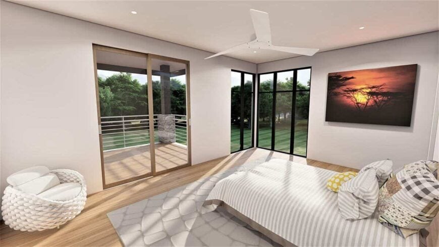 The primary bedroom has a private balcony and large corner windows overlooking the lush backyard.