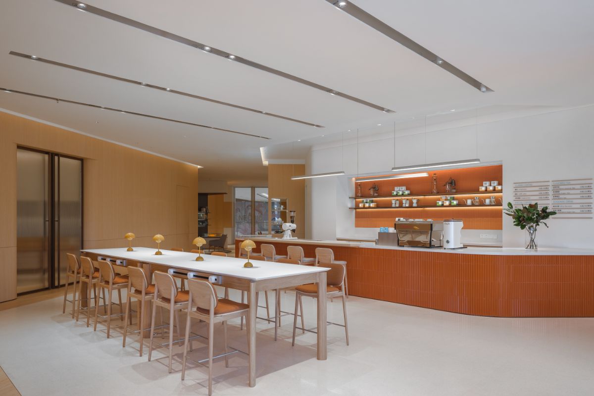 The wooden dining table near the kitchen.