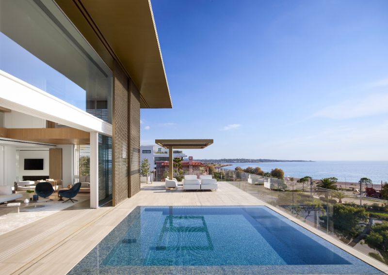 The swimming pool area with overlooking view of the beach.