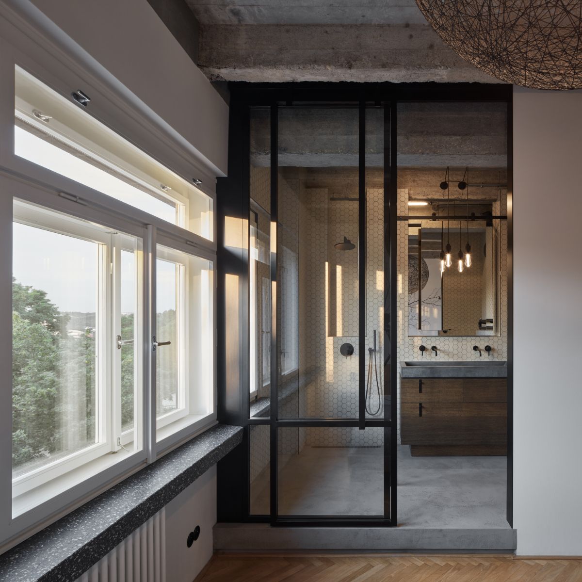The primary bathroom with glass -enclosed shower room.