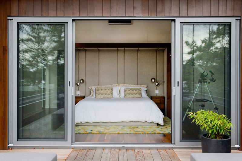 The master bedroom with large glass sliding door leading to the terrace.