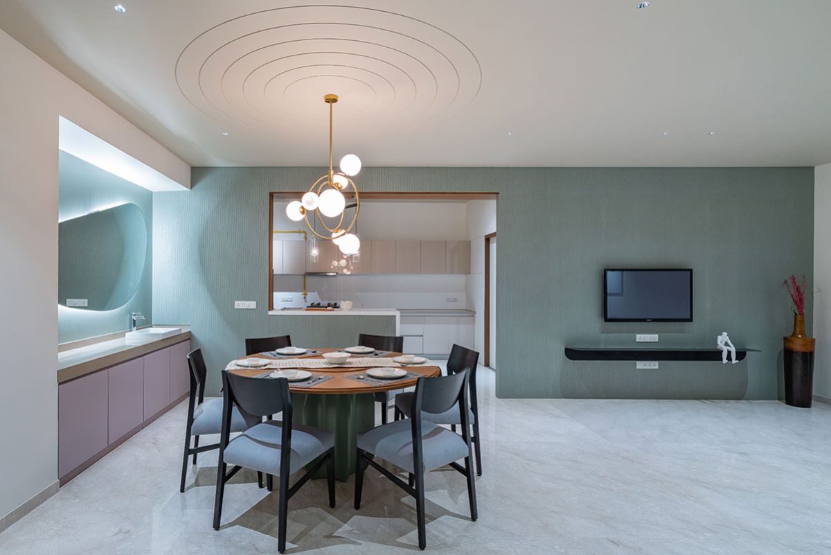 A compact 6-seater dining table with a resin pendant light.