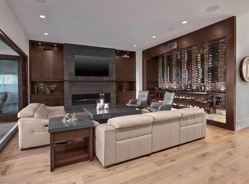 The living room includes a wine cabinet enclosed in sliding glass doors.