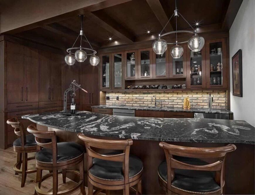 A large wet bar equipped with glass-front and wooden cabinets, marble countertops, and four seating.