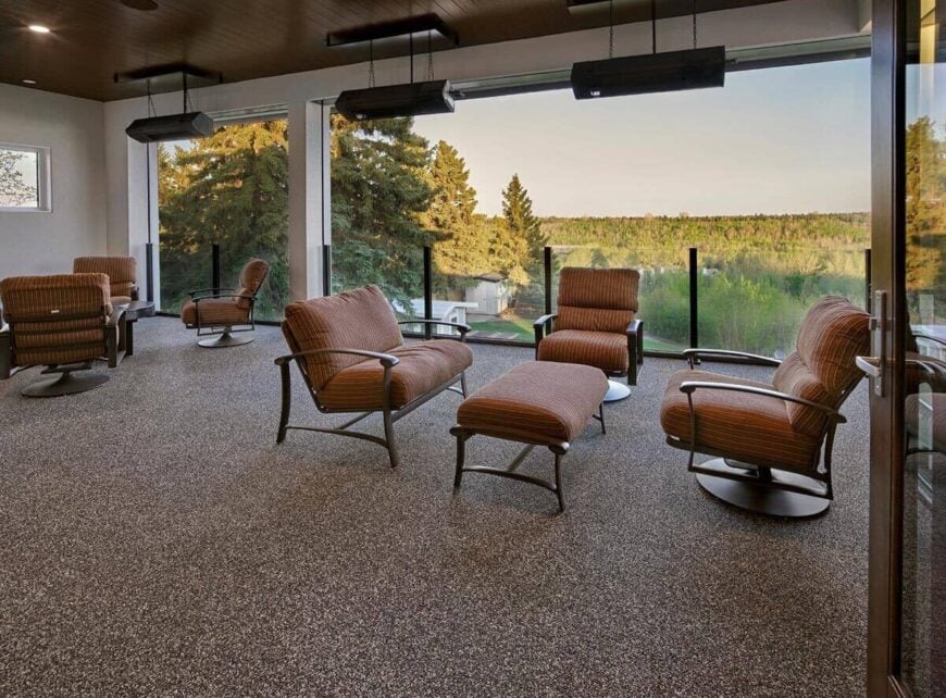 The screened deck has multiple seating areas and stunning views of the surrounding landscape.