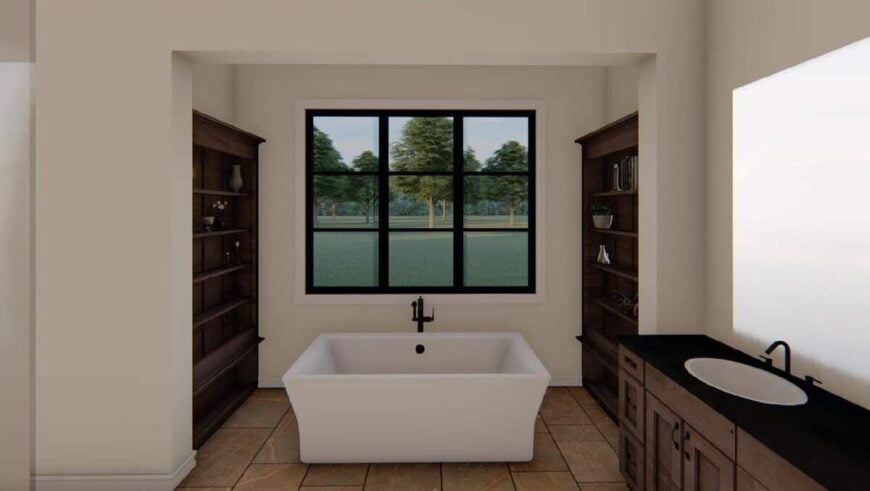 Primary bathroom with a sink vanity and a freestanding tub nestled between the built-in shelves.