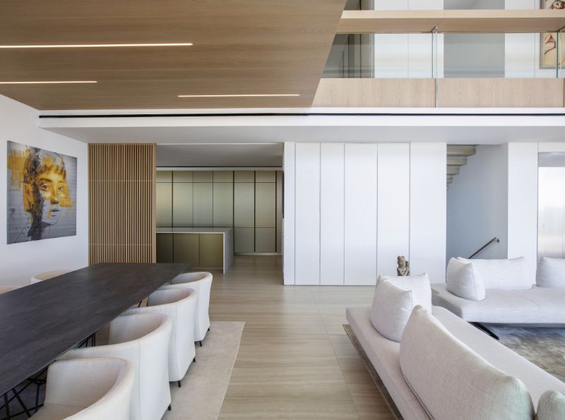 The dining area connected to double-height living space.