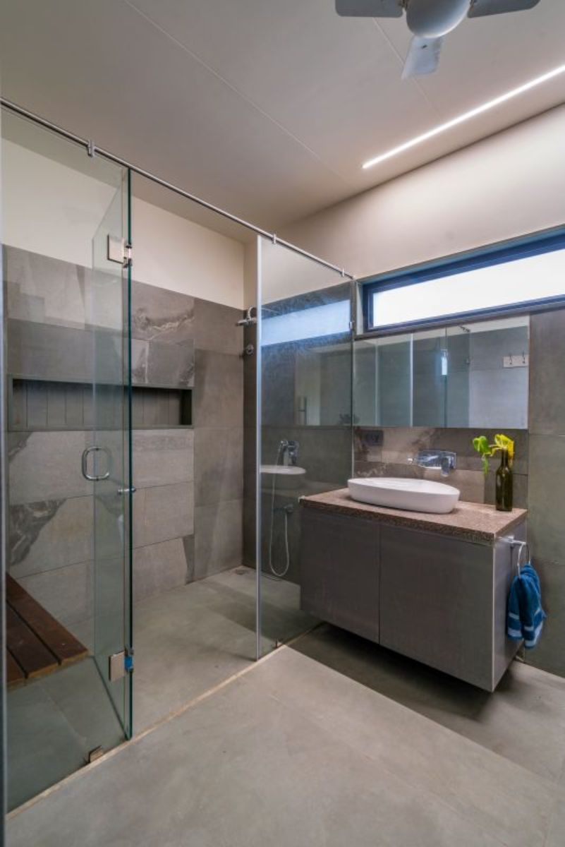 The bathroom with glass-enclosed shower area.