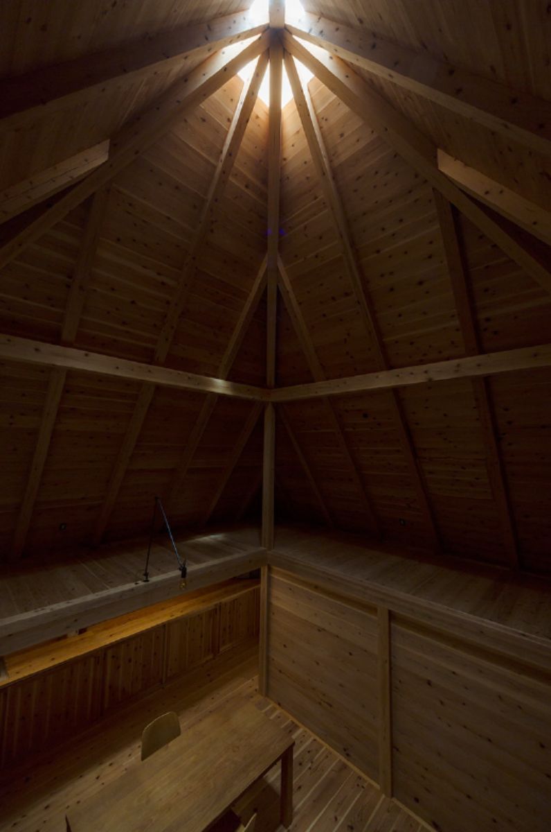 A sky lit dining room with double-height ceiling.